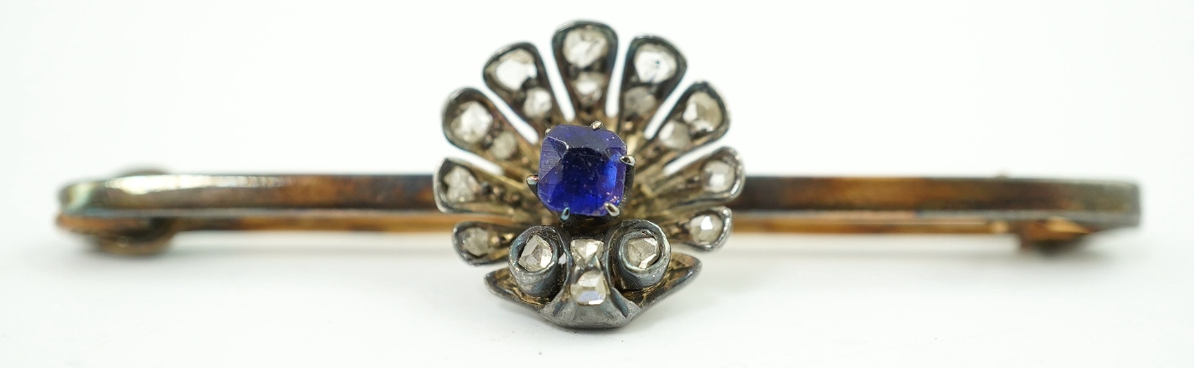 A sapphire and diamond fan shaped brooch, unmarked. Condition - solder to pin, otherwise fair